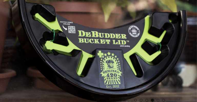 The Debudder Bucket Lid outdoors, mobile and ready for use at any farm location.